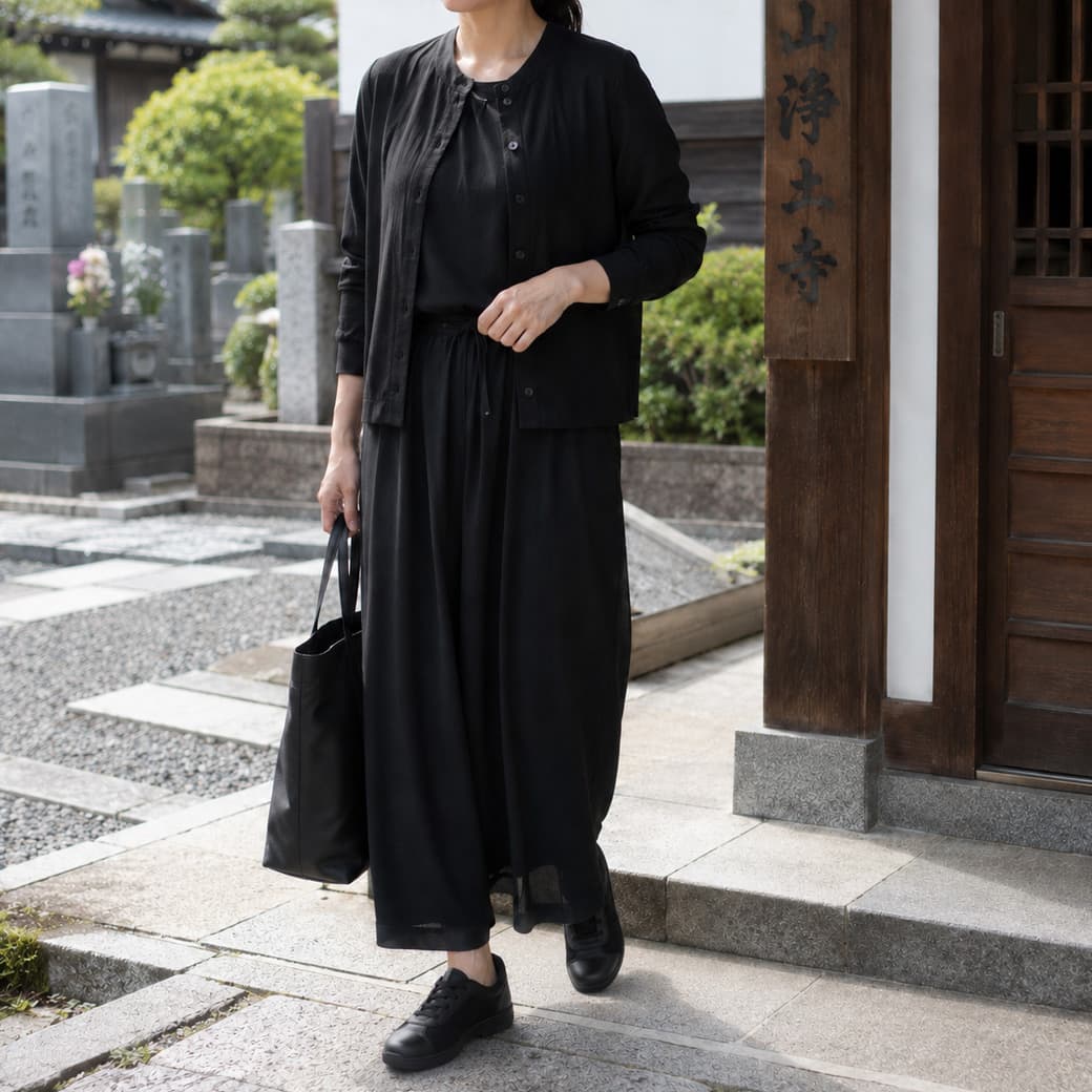 お盆の帰省で黒い装いを整える女性のイメージ